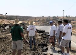 picture raceway staff looking at destruction of track
